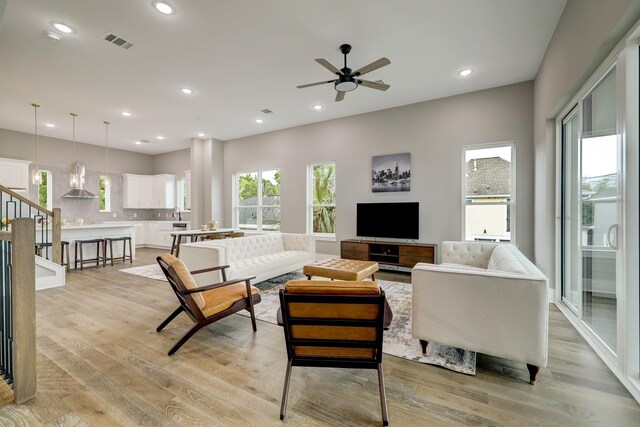 1407 W 23rd St, Houston, TX 77008 - living room featuring light wood-style floors, a ceiling fan, recessed lighting, and stairway