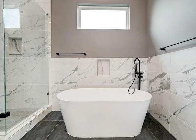 1407 W 23rd St, Houston, TX 77008 - full bath with tile walls, a soaking tub, tiled shower, and a wainscoted wall