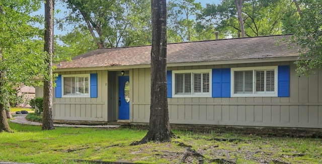 2 Raccoon Ln, The Woodlands, TX 77380 - view of front of house featuring roof with shingles