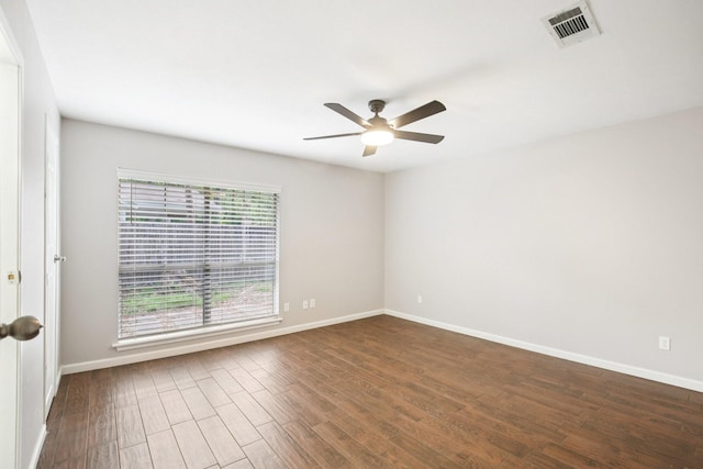 2 Raccoon Ln, The Woodlands, TX 77380 - unfurnished room with a ceiling fan, dark wood-type flooring, and baseboards