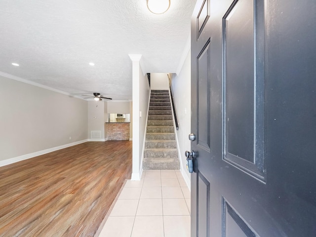 6402 Del Monte Dr Unit 20, Houston, TX 77057 - entrance foyer with ceiling fan, baseboards, a textured ceiling, stairway, and light wood-style flooring