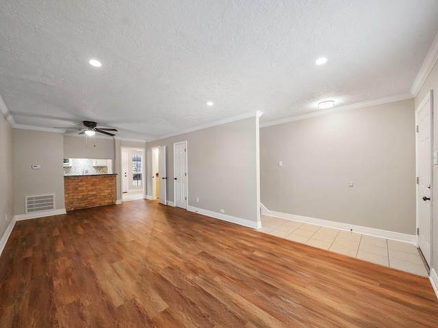 6402 Del Monte Dr Unit 20, Houston, TX 77057 - unfurnished living room with wood finished floors, a textured ceiling, a ceiling fan, baseboards, and ornamental molding