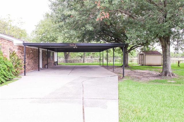 912 Robinson Rd, La Porte, TX 77571 - view of car parking with a storage shed, concrete driveway, and a carport