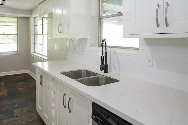 912 Robinson Rd, La Porte, TX 77571 - kitchen featuring a sink, baseboards, tasteful backsplash, white cabinets, and dark stone finish flooring