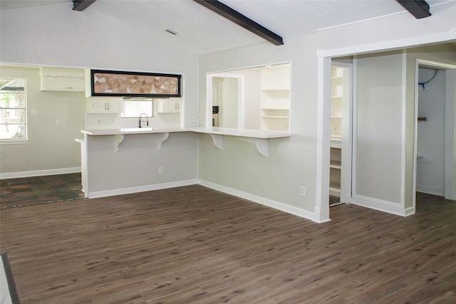 912 Robinson Rd, La Porte, TX 77571 - unfurnished living room with dark wood-style flooring, baseboards, and a sink