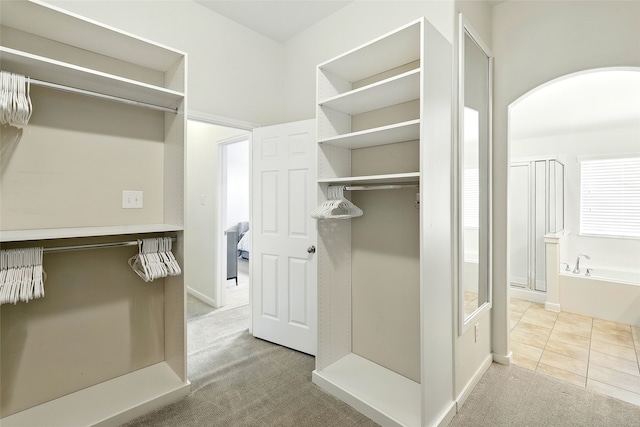 22210 Pacific Ocean Dr, Spring, TX 77388 - spacious closet featuring carpet and arched walkways