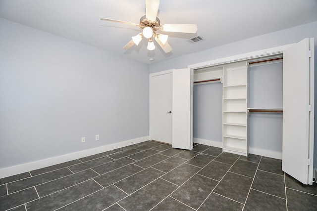 8642 Meadowcroft Dr, Houston, TX 77063 - unfurnished bedroom with a closet, dark tile patterned flooring, ceiling fan, and baseboards