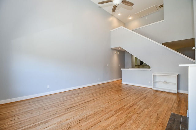 8642 Meadowcroft Dr, Houston, TX 77063 - unfurnished living room with high vaulted ceiling, wood finished floors, a ceiling fan, baseboards, and built in features
