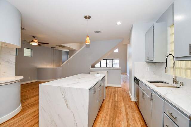 8642 Meadowcroft Dr, Houston, TX 77063 - kitchen with a sink, gray cabinetry, ceiling fan, baseboards, and light wood finished floors