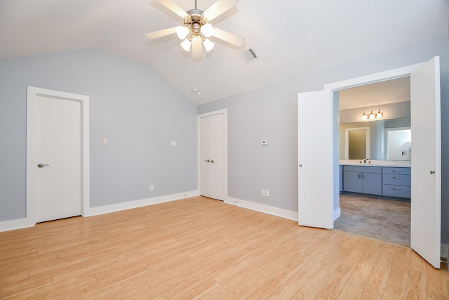 8642 Meadowcroft Dr, Houston, TX 77063 - unfurnished bedroom with lofted ceiling, light wood-style flooring, ensuite bath, baseboards, and a sink