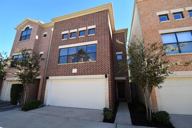 8642 Meadowcroft Dr, Houston, TX 77063 - view of front facade with driveway, a garage, and brick siding