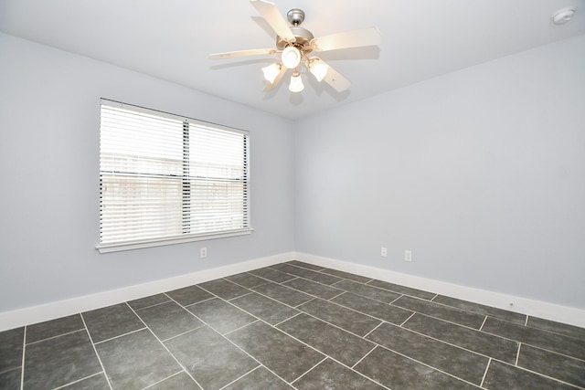 8642 Meadowcroft Dr, Houston, TX 77063 - unfurnished room with a smoke detector, dark tile patterned floors, a ceiling fan, and baseboards