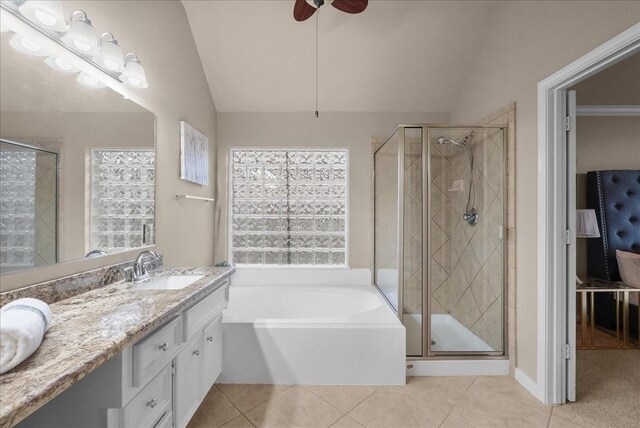 2512 Garnetfield Ln, Friendswood, TX 77546 - bathroom with vaulted ceiling, double vanity, tile patterned floors, a garden tub, and a stall shower