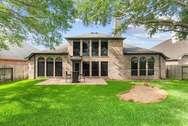 2512 Garnetfield Ln, Friendswood, TX 77546 - back of property featuring a chimney, a patio, brick siding, and a shingled roof