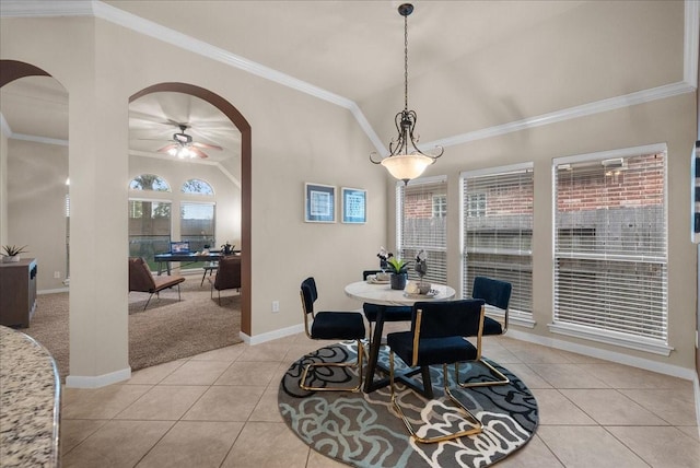 2512 Garnetfield Ln, Friendswood, TX 77546 - dining room with arched walkways, light tile patterned floors, baseboards, vaulted ceiling, and light colored carpet