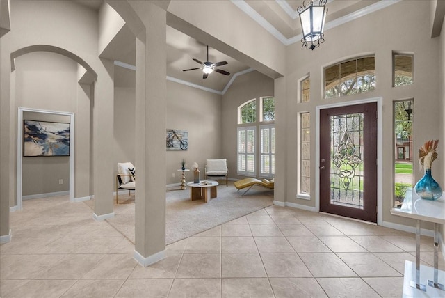 2512 Garnetfield Ln, Friendswood, TX 77546 - entryway with crown molding, light tile patterned flooring, baseboards, a towering ceiling, and a ceiling fan