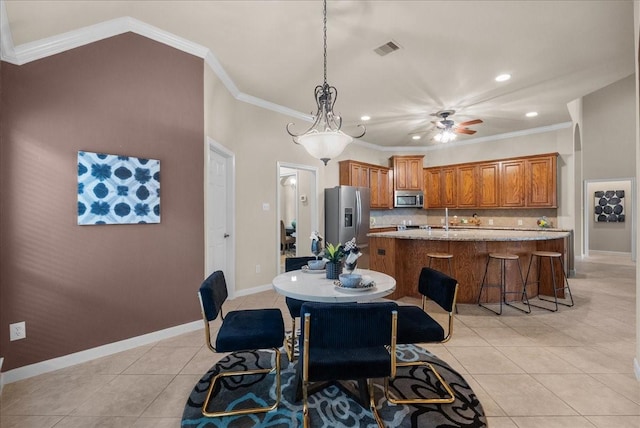 2512 Garnetfield Ln, Friendswood, TX 77546 - dining space featuring light tile patterned flooring, crown molding, ceiling fan, baseboards, and recessed lighting