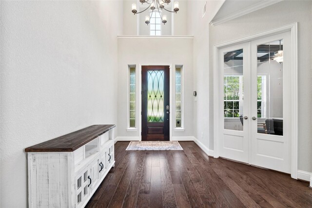 315 Lagarto Way, Pinehurst, TX 77362 - foyer featuring french doors, dark wood-type flooring, a chandelier, and baseboards