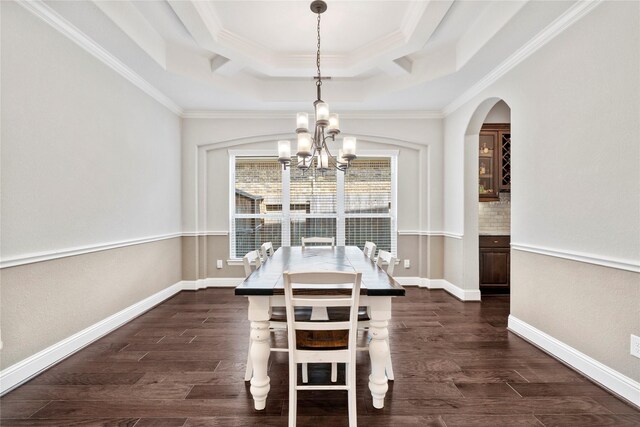 315 Lagarto Way, Pinehurst, TX 77362 - dining room with a tray ceiling, a chandelier, dark wood-style flooring, crown molding, and arched walkways