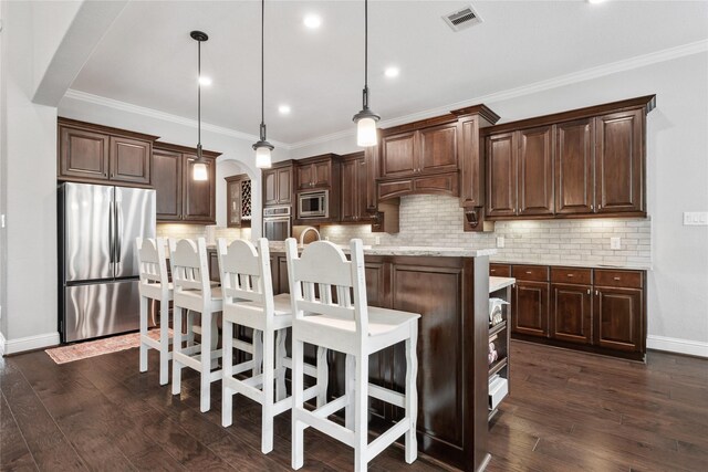 315 Lagarto Way, Pinehurst, TX 77362 - kitchen featuring appliances with stainless steel finishes, arched walkways, dark brown cabinetry, tasteful backsplash, and crown molding