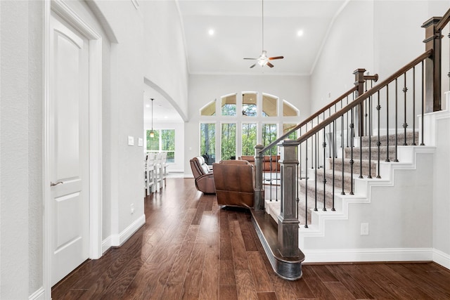 315 Lagarto Way, Pinehurst, TX 77362 - foyer entrance featuring ceiling fan, dark wood-style flooring, baseboards, ornamental molding, and stairway