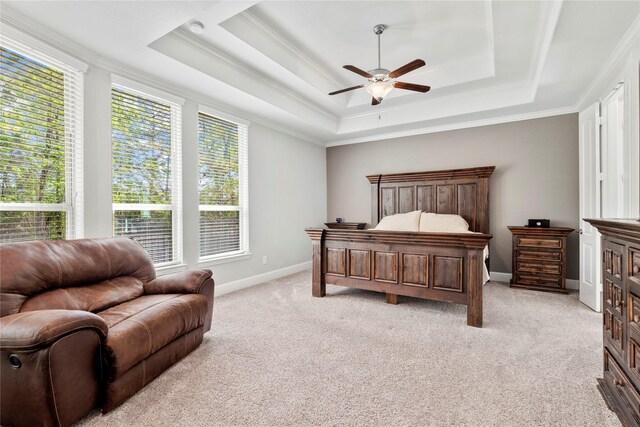 315 Lagarto Way, Pinehurst, TX 77362 - bedroom featuring ornamental molding, a raised ceiling, light colored carpet, baseboards, and a ceiling fan