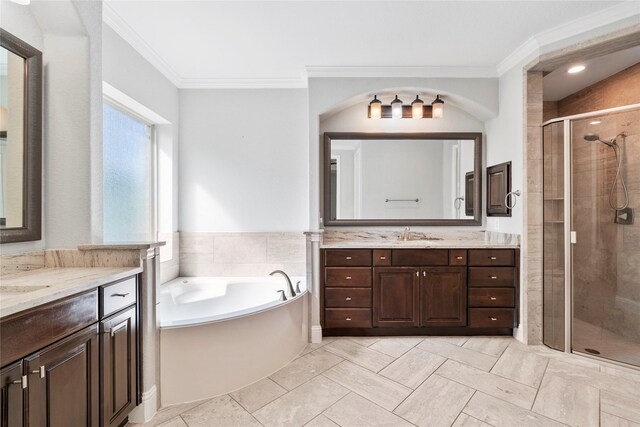 315 Lagarto Way, Pinehurst, TX 77362 - bathroom featuring two vanities, a shower stall, crown molding, and a garden tub