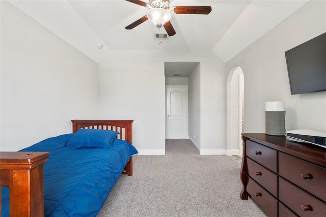 315 Lagarto Way, Pinehurst, TX 77362 - bedroom with light carpet, vaulted ceiling, arched walkways, baseboards, and a ceiling fan