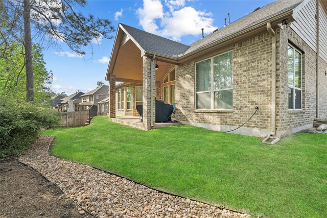 315 Lagarto Way, Pinehurst, TX 77362 - view of side of home with ceiling fan, a patio area, brick siding, and roof with shingles