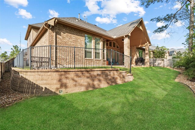 315 Lagarto Way, Pinehurst, TX 77362 - back of property featuring brick siding and roof with shingles