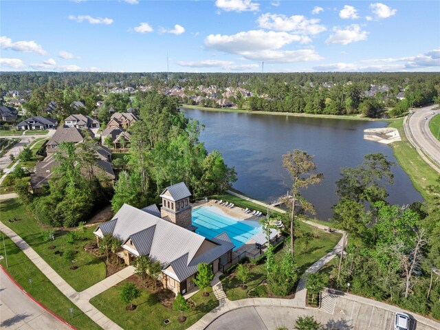 315 Lagarto Way, Pinehurst, TX 77362 - aerial view of residential area featuring a large body of water and a pool area
