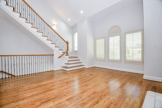 608 Westcott St, Houston, TX 77007 - entryway with a towering ceiling, light wood-style flooring, arched walkways, recessed lighting, and stairs