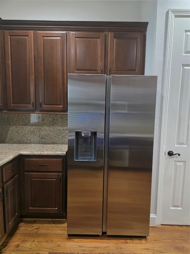 608 Westcott St, Houston, TX 77007 - kitchen featuring stainless steel fridge, light wood-style flooring, dark brown cabinetry, and light stone countertops