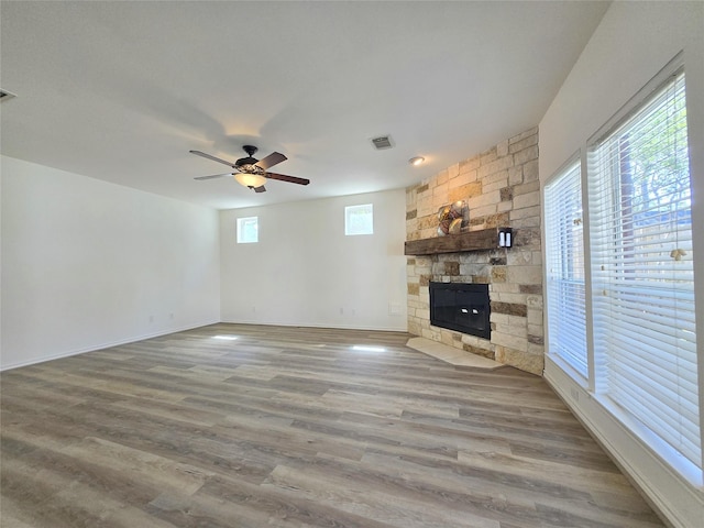 6415 Taimer Ct, Sugar Land, TX 77479 - unfurnished living room with a fireplace, ceiling fan, wood finished floors, and baseboards