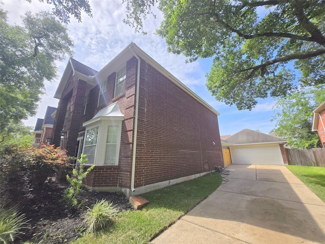 6415 Taimer Ct, Sugar Land, TX 77479 - view of side of home featuring brick siding and a detached garage