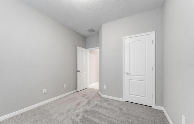 4827 Austin Meadow Ln, Katy, TX 77449 - unfurnished bedroom with carpet, baseboards, and a textured ceiling