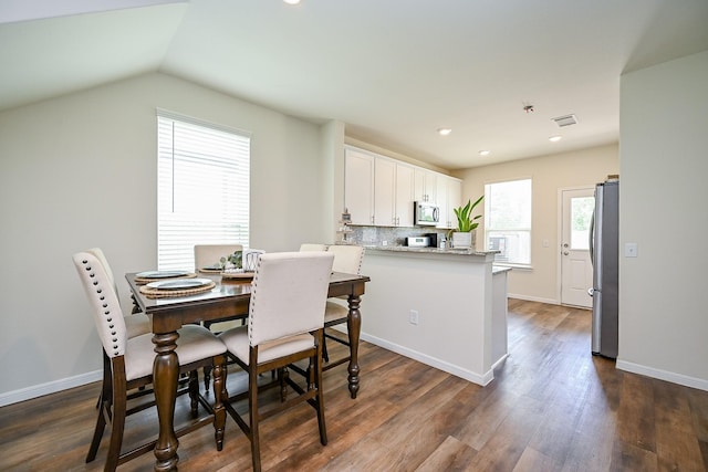 4611 Prairie Chase Dr, Houston, TX 77069 - dining space featuring dark wood-type flooring, recessed lighting, baseboards, and lofted ceiling
