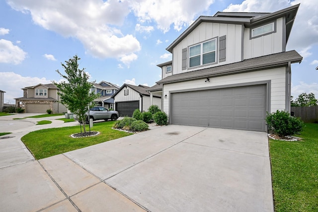 4611 Prairie Chase Dr, Houston, TX 77069 - view of front of home featuring board and batten siding, an attached garage, a front yard, and driveway