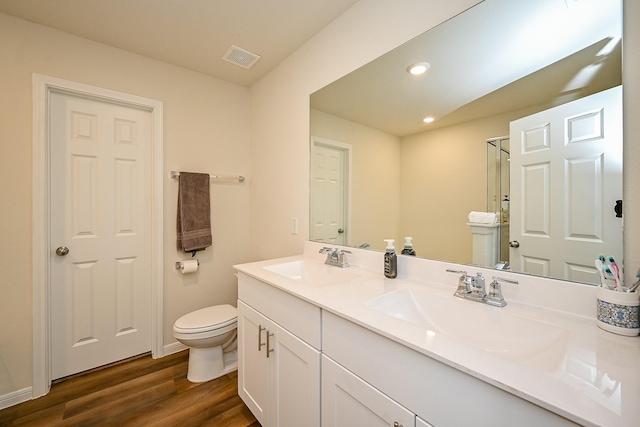 4611 Prairie Chase Dr, Houston, TX 77069 - bathroom with double vanity, toilet, wood finished floors, recessed lighting, and baseboards