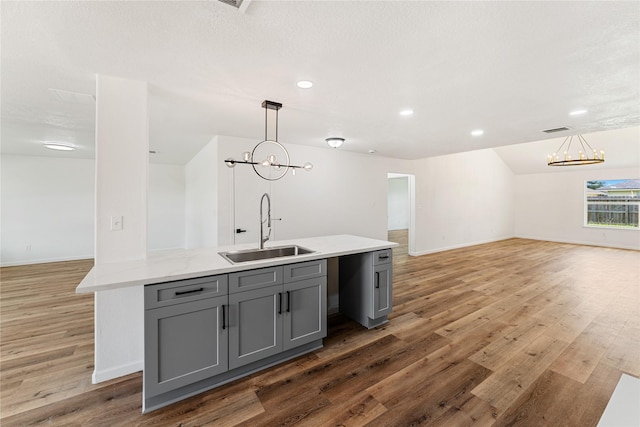 7815 Brook Trail Cir, Houston, TX 77040 - kitchen with a sink, open floor plan, a chandelier, gray cabinetry, and recessed lighting
