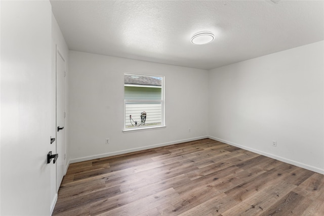 7815 Brook Trail Cir, Houston, TX 77040 - unfurnished room featuring wood finished floors, baseboards, and a textured ceiling