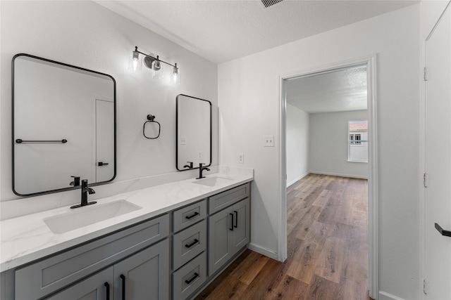 7815 Brook Trail Cir, Houston, TX 77040 - full bath featuring wood finished floors, double vanity, and baseboards