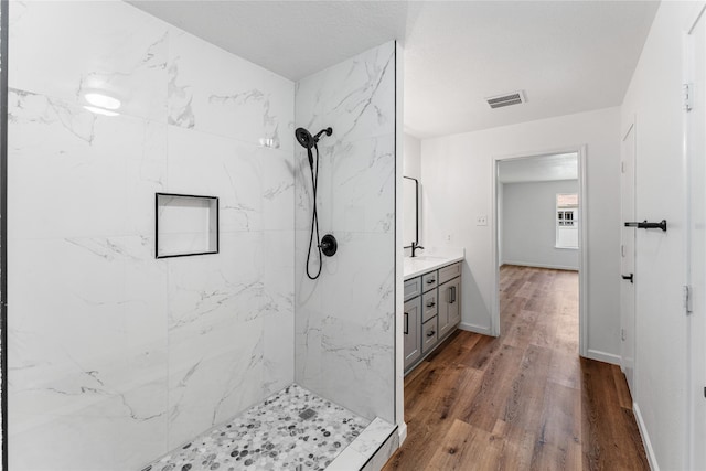 7815 Brook Trail Cir, Houston, TX 77040 - bathroom with a marble finish shower, wood finished floors, vanity, and baseboards