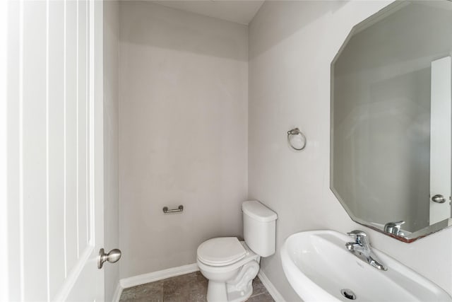 8014 Oxbow Manor Ln, Cypress, TX 77433 - half bath with toilet, a sink, baseboards, and tile patterned floors