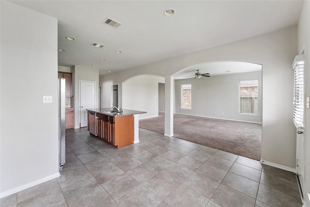 8014 Oxbow Manor Ln, Cypress, TX 77433 - kitchen featuring arched walkways, light colored carpet, a ceiling fan, baseboards, and recessed lighting