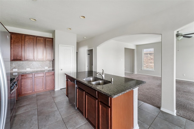 8014 Oxbow Manor Ln, Cypress, TX 77433 - kitchen with a sink, arched walkways, tile patterned floors, open floor plan, and a ceiling fan