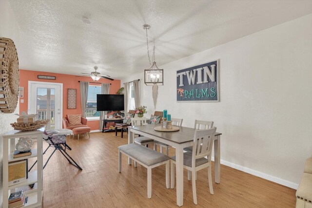 123 Howard Ave, Surfside Beach, TX 77541 - dining room featuring wood finished floors, baseboards, ceiling fan, and a textured ceiling