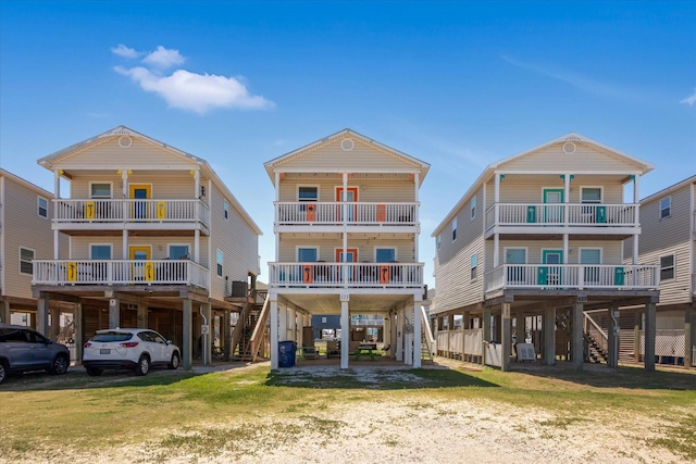 123 Howard Ave, Surfside Beach, TX 77541 - rear view of house with a carport, stairs, and driveway