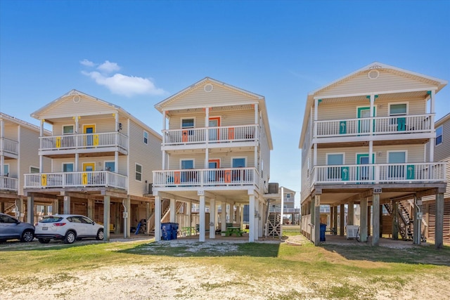 123 Howard Ave, Surfside Beach, TX 77541 - view of front of property with stairs, a carport, and a balcony