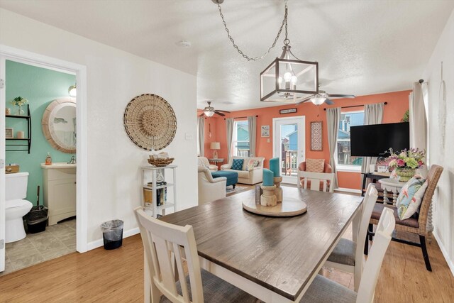 123 Howard Ave, Surfside Beach, TX 77541 - dining space featuring a ceiling fan, healthy amount of natural light, light wood-type flooring, and baseboards